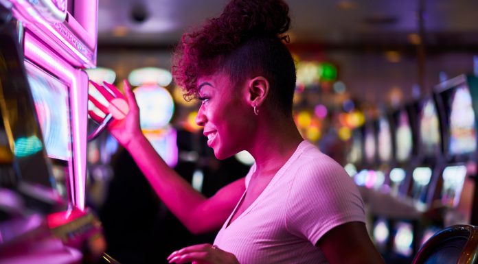 Online Casino is the Future of Entertainment happy woman gambling at casino playing slot machine