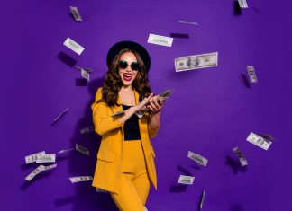 Dream Come True: How to Have Fun and Make Money Portrait of her she nice attractive cheerful cheery positive trendy luxury wavy-haired lady throwing 100 hundred million expenses isolated over bright vivid shine violet lilac background