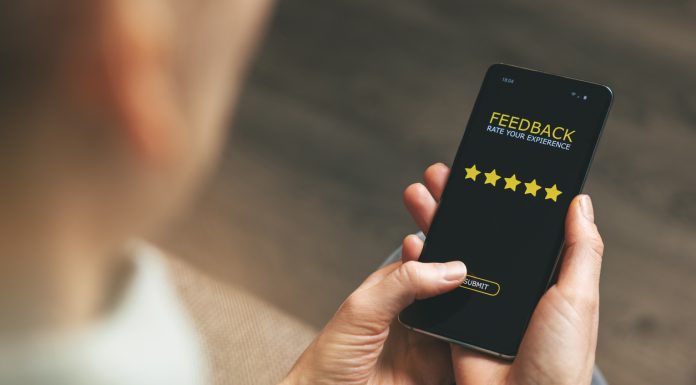 customer feedback - woman using phone to give 5 star rating for good service