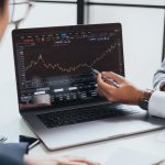 The Fundament Of Bitcoin Investment – Genuine Or Baseless Businessman talking about investment stock market and graph from computer laptop with broker trader, giving money plan management and analysis