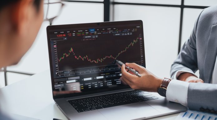 Businessman talking about investment stock market and graph from computer laptop with broker trader, giving money plan management and analysis