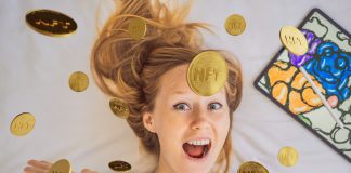 NFT Young woman, a digital artist, creates digital art on a tablet at home and shows a coin with the inscription NTF - non fungible token. Remote work, digital nomad, digital painting, animation, video