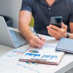 Young male investor analyzing information