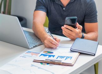 Young male investor analyzing information