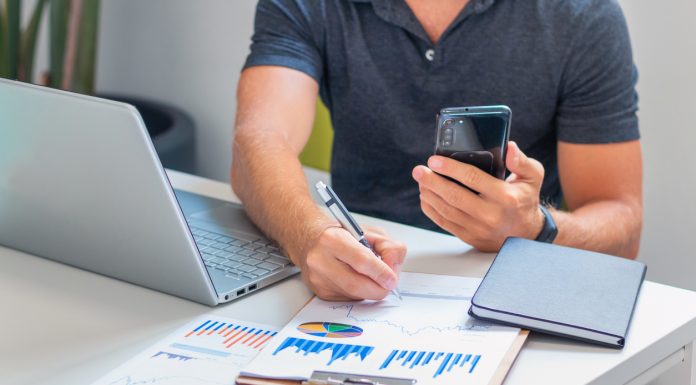 Young male investor analyzing information