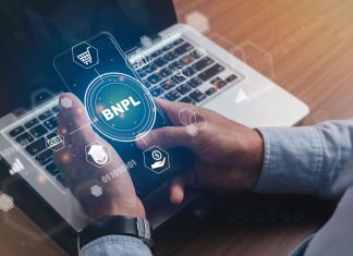 What Is BNPL And Is It Safe? Businessmen holding a smartphone with icons of BNPL with online shopping icons technology. BNPL Buy now pay later online shopping concept.