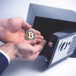 What is Bitcoin Private (BTCP)? Â Safe Deposit. Symbol of cryptocurrency safety. The man puts a physical bitcoin in small Residential Vault. Toned soft focus picture.