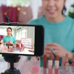 Asia woman micro influencer record live viral video camera at home studio. Happy fun talk speak advice review hobby in media. Vlogger selfie shoot enjoy work show smile teach like share app.