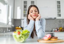 Teenage girl chooses between donuts and vegetable salad