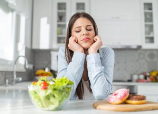 5 Foods That Treat Erectile Dysfunction Teenage girl chooses between donuts and vegetable salad