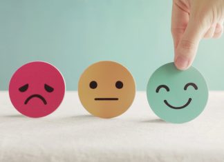 Hand choosing green happy smiley face paper cut, product, user, service feedback rating and customer reveiw, experience, satisfaction survey, psychology mental health test concept