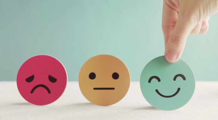 Start Taking Pulse Surveys and Keep Employees Engaged Hand choosing green happy smiley face paper cut, product, user, service feedback rating and customer reveiw, experience, satisfaction survey, psychology mental health test concept
