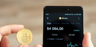 Hands holding a smartphone with bitcoin exchange rate