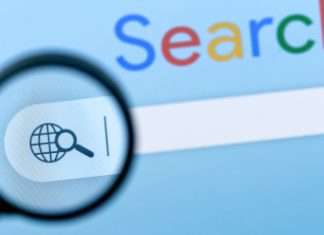 Internet search bar in browser with magnifier on computer monitor screen.