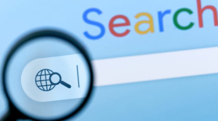 Internet search bar in browser with magnifier on computer monitor screen.