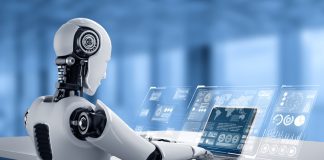 Robot humanoid use laptop and sit at table for big data analytic