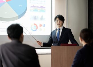 Italki Review Asian businessman giving a presentation at a conference