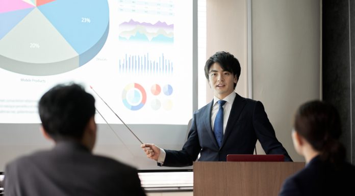 Italki Review Asian businessman giving a presentation at a conference