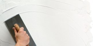 hand holding plastering tool