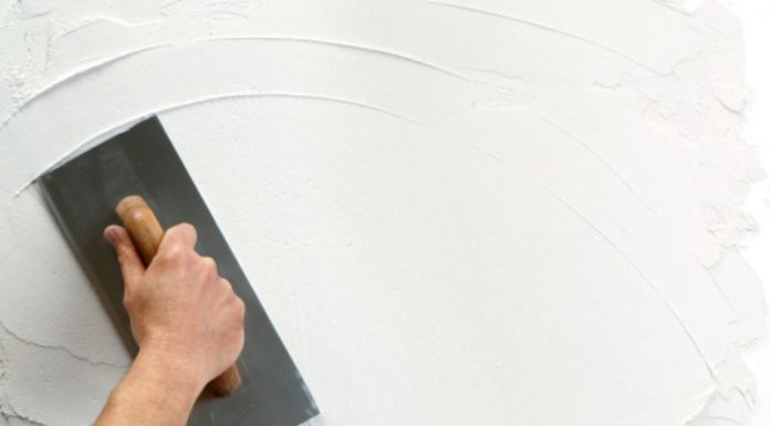 hand holding plastering tool