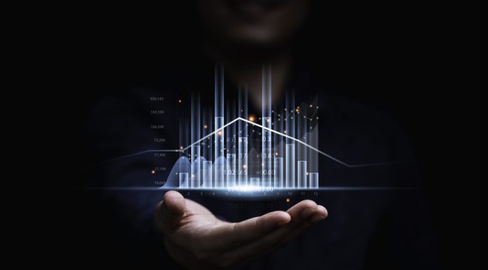 Businessman or trader showing glowing virtual technical investment graph chart for analysis stock market , Banking financial and planing concept.