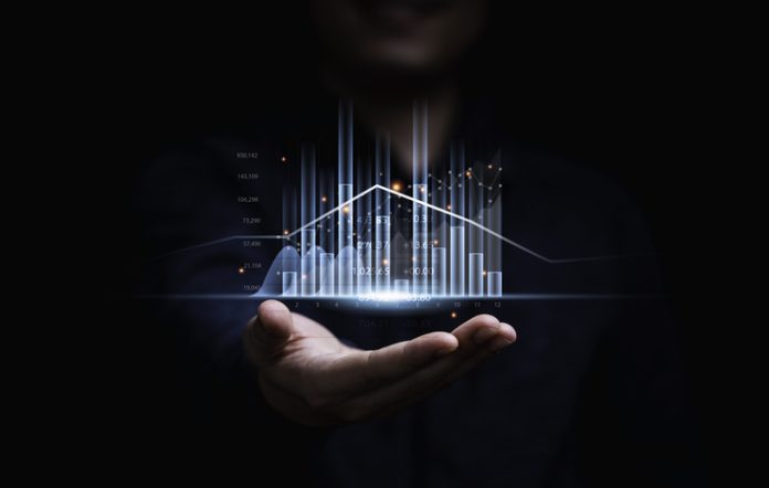 Businessman or trader showing glowing virtual technical investment graph chart for analysis stock market , Banking financial and planing concept.