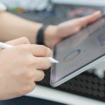 Do Small Businesses Really Need CRM? close up employee accountant man hand use stylus pen to checklist of monthly statistics and performance or of company