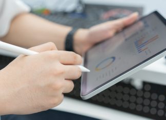 Do Small Businesses Really Need CRM? close up employee accountant man hand use stylus pen to checklist of monthly statistics and performance or of company