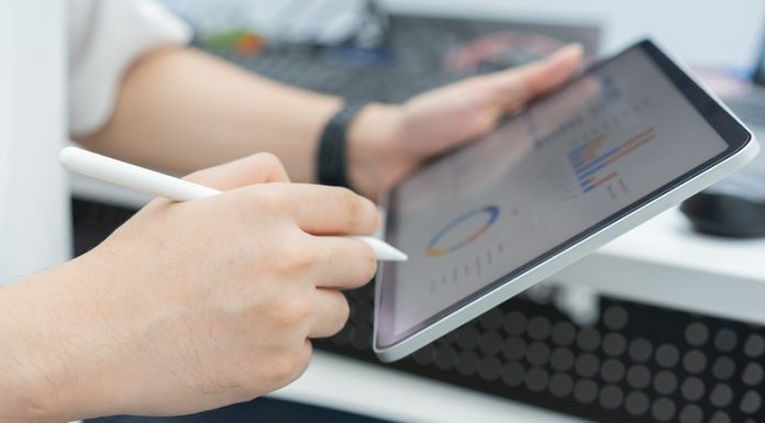 Do Small Businesses Really Need CRM? close up employee accountant man hand use stylus pen to checklist of monthly statistics and performance or of company