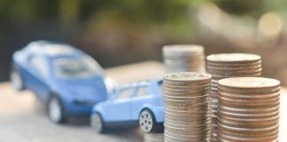 Coins stack and car model on wood table
