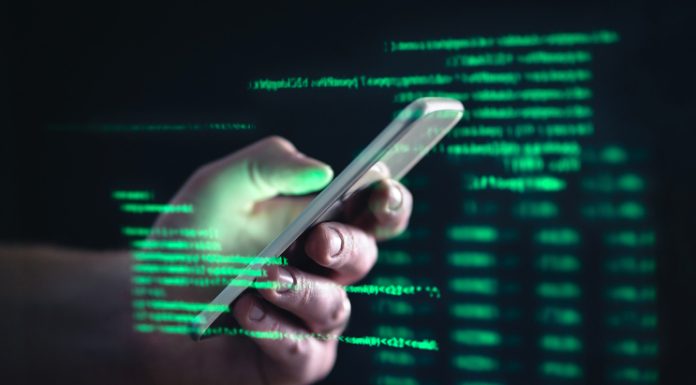 101 Hire a Hacker To Exploit iPhone Sensitive Information. Darkweb, darknet and hacking concept. Hacker with cellphone. Man using dark web with smartphone. Mobile phone fraud, online scam and cyber security threat. Scammer using stolen cell.