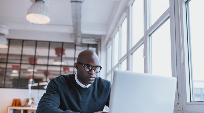 Businessman working on laptop in office
