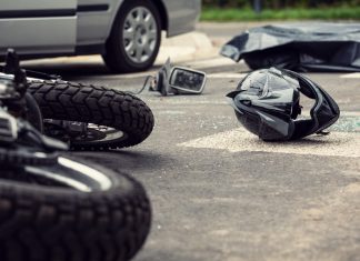 Motorcycle and helmet on the street after dangerous traffic inci