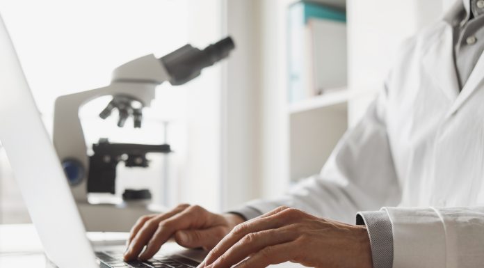 5 Pros And Cons Of Leasing Scientific Equipment For Your Business Scientist or student using laptop computer and microscope