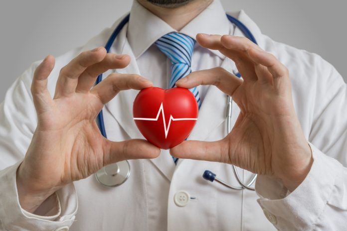 Doctor holds red heart in hands. Access to Healthcare