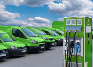 Electric vehicles charging station on a background of a row of vans
