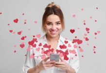 Love message for Valentine day - hearts flying out smartphone in girls hands