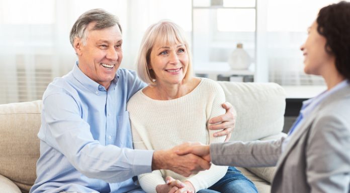 The Importance of Health Insurance for Senior Citizens: A Comprehensive Guide Female Real Estate Agent handshaking happy mature couple at home