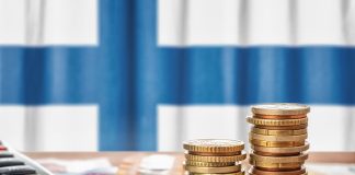 Legal Ways to Earn Money Online in Finland Euro banknotes and coins in front of the national flag of Finland
