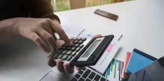 Revive Your Business: How to Secure a Bad Credit Business Line of Credit woman working with finance calculate on calculator and using computer laptop and document data chart in office room.