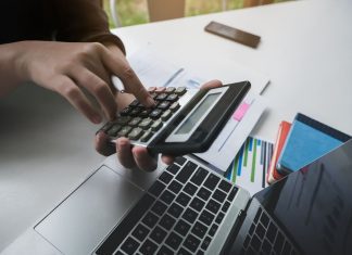 Revive Your Business: How to Secure a Bad Credit Business Line of Credit woman working with finance calculate on calculator and using computer laptop and document data chart in office room.