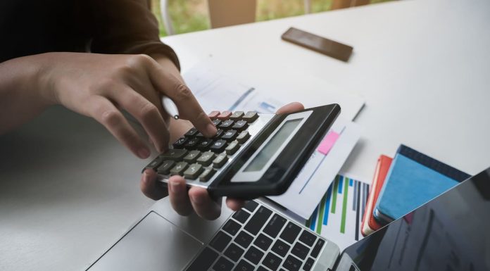 Revive Your Business: How to Secure a Bad Credit Business Line of Credit woman working with finance calculate on calculator and using computer laptop and document data chart in office room.