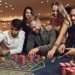 Happy friends play roulette in a casino.