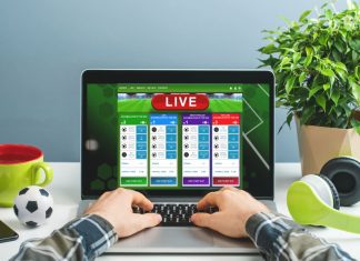 Big Data in Online Gambling: Using Analytics for Competitive Advantage Man using laptop for betting online at bookmaker's website. Sport, gambling, money win concept.