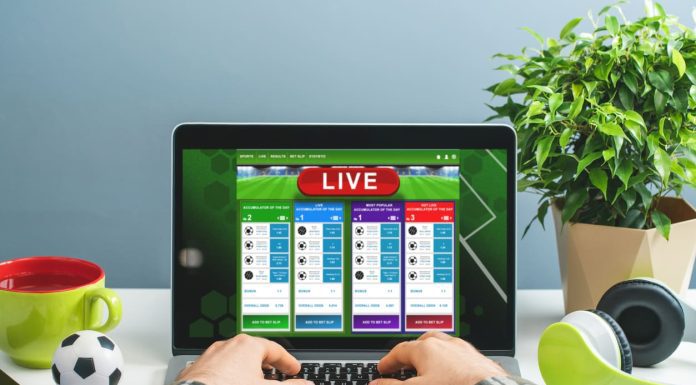 Big Data in Online Gambling: Using Analytics for Competitive Advantage Man using laptop for betting online at bookmaker's website. Sport, gambling, money win concept.