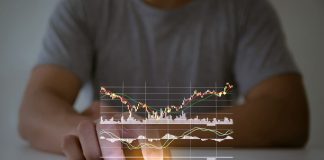 Are you on the Lookout for a Promising Stock Investment Opportunity That Combines Innovation, Technology? A man use checking a business graph with a hand touch screen smartphone technology"n