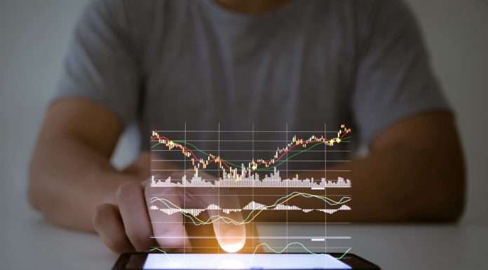 Are you on the Lookout for a Promising Stock Investment Opportunity That Combines Innovation, Technology? A man use checking a business graph with a hand touch screen smartphone technology"n
