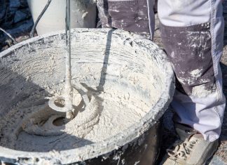 Plasterer mixing exterior plaster