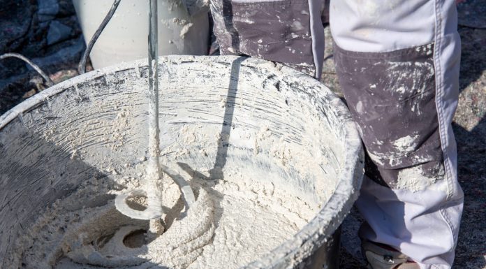 Plasterer mixing exterior plaster