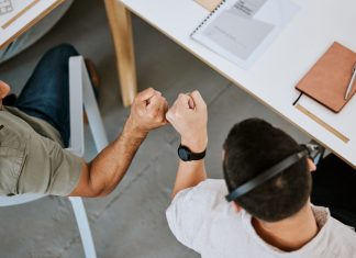 Leveraging Job Portals for Career Success Excited call centre agents, fist bump and celebrating deal, promotion and sale from above in office. Motivated, happy and successful telemarketing colleagues or customer support operators cheering